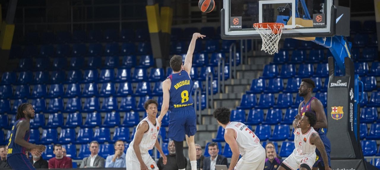 Basketball game in a Spanish arena with players competing on court