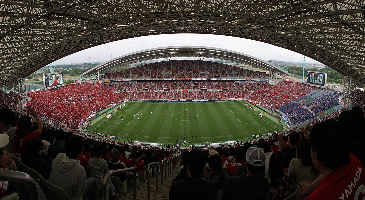 A packed Japanese football stadium during a J-League match, the kind of atmosphere touring teams experience in Japan
