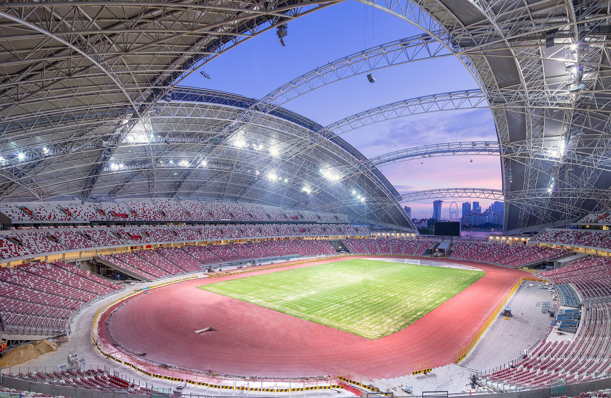 Modern Singapore sports stadium with the Marina Bay skyline in the background