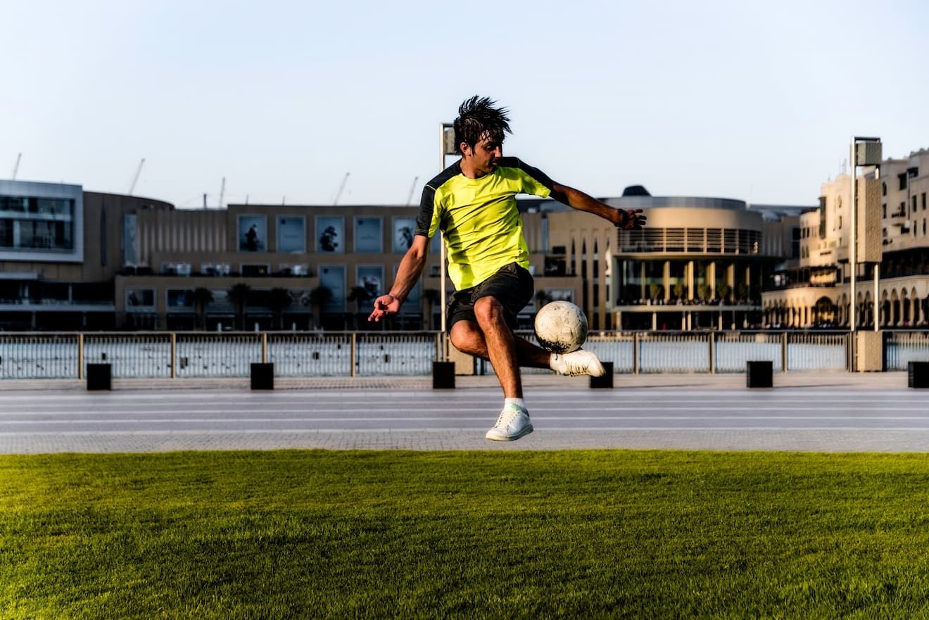 A young footballer training individually with the ball, developing technical mastery during an elite player internship