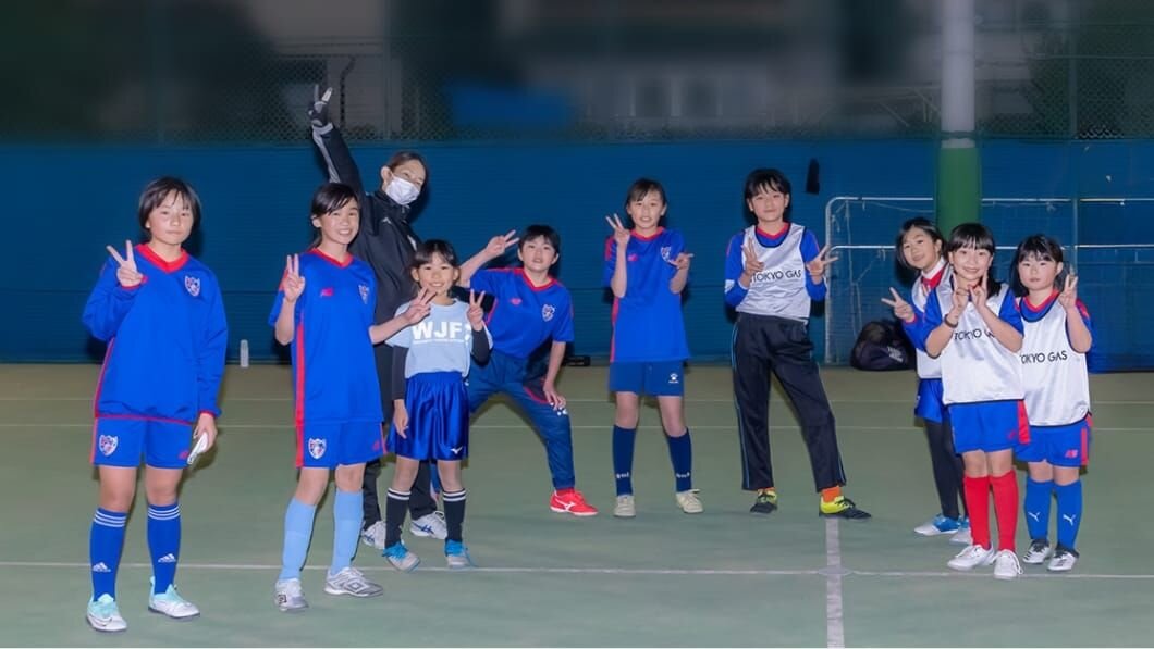 Youth football players training on a pitch in Japan on a sports tour from Australia