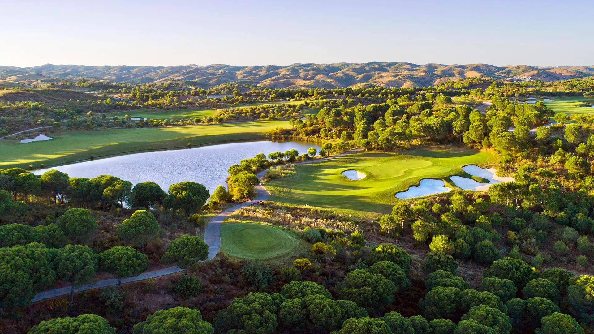 Luxury golf resort with championship course overlooking the ocean at sunset