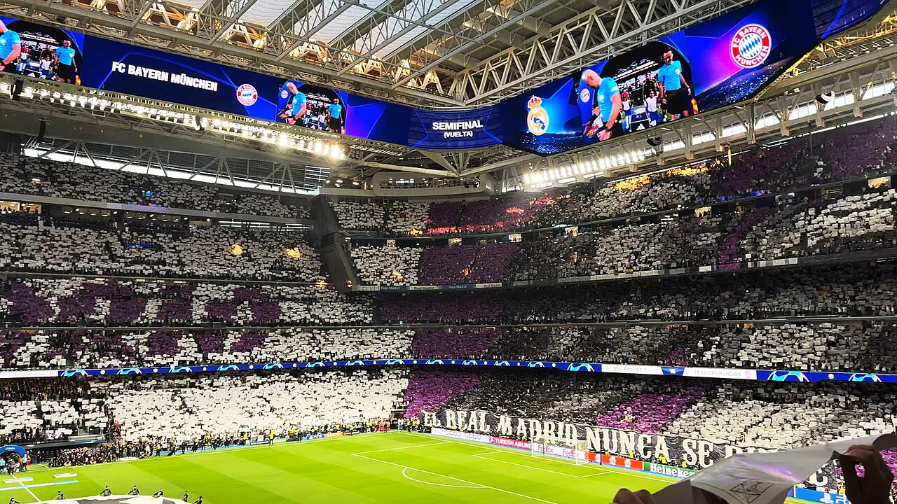 Iconic European football stadium at night ready for a match