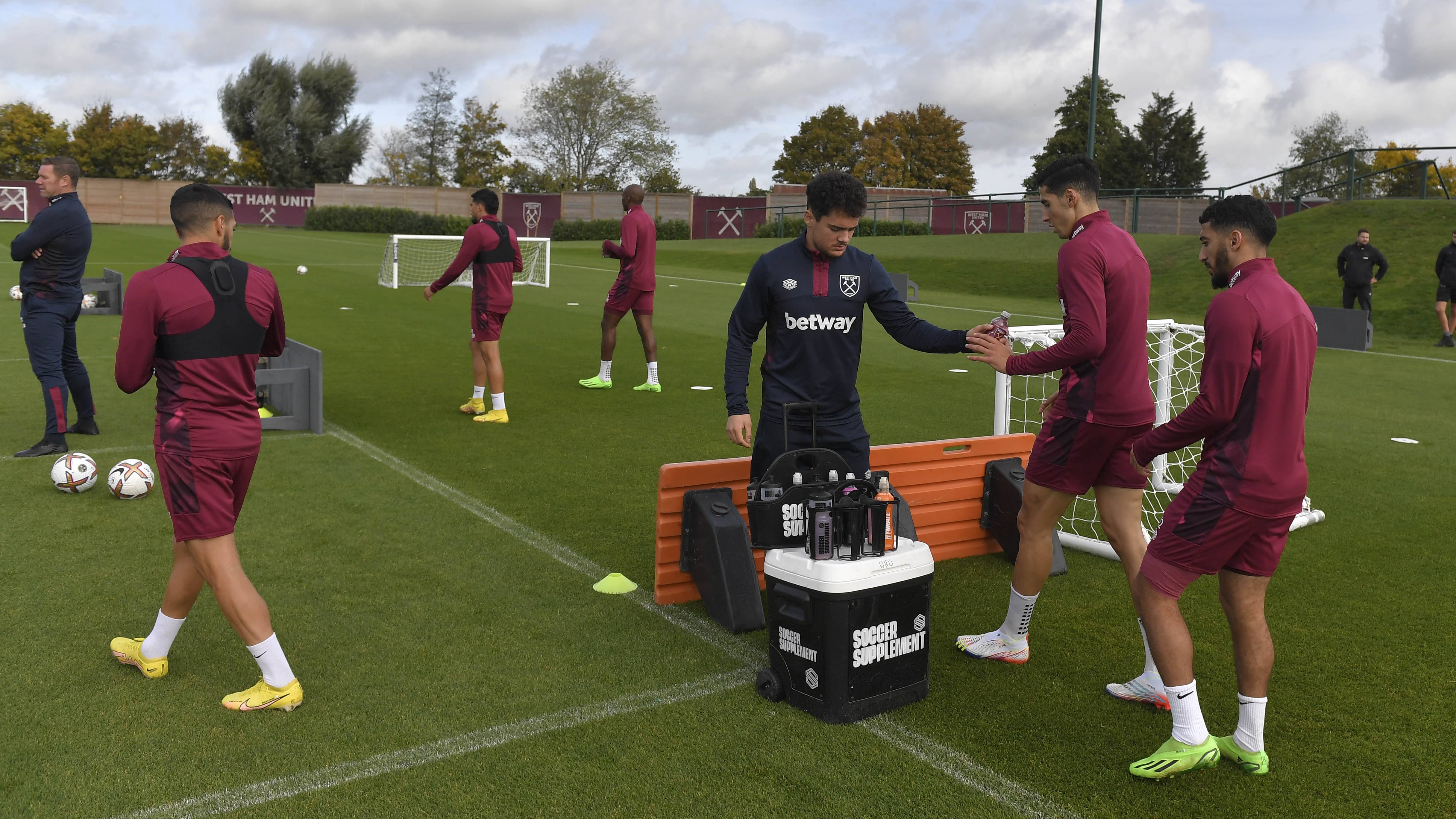 Professional footballers running fitness drills during a pre-season training camp