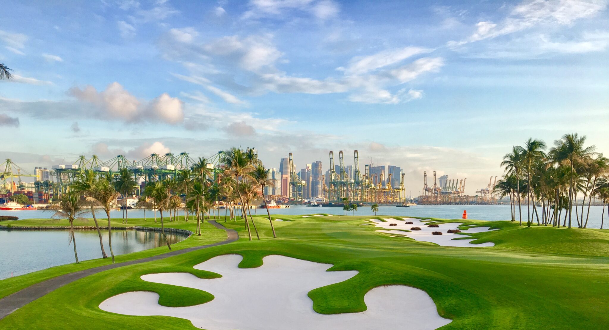 Lush tropical golf course in Asia with palm trees and manicured fairways