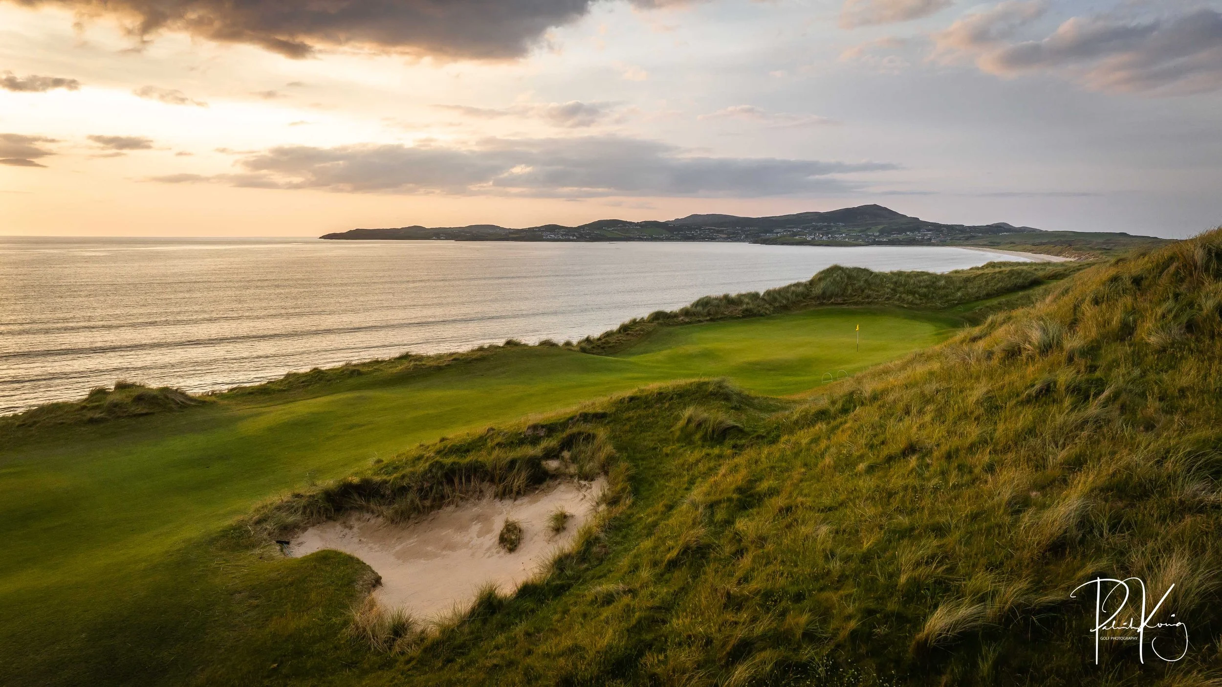 Coastal links golf course in Europe at sunset with the sea behind