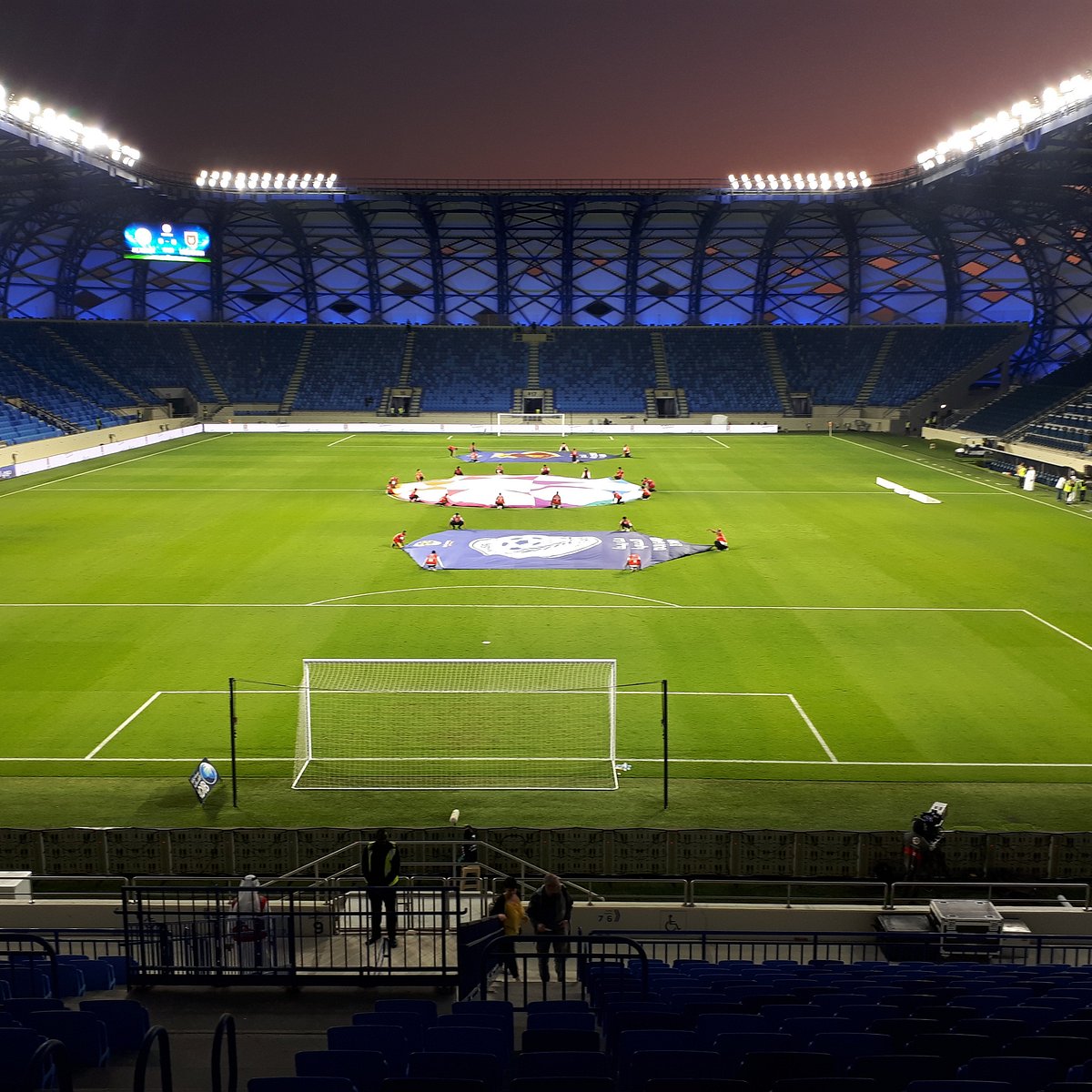 A floodlit stadium used for pre-season friendly matches by professional football teams