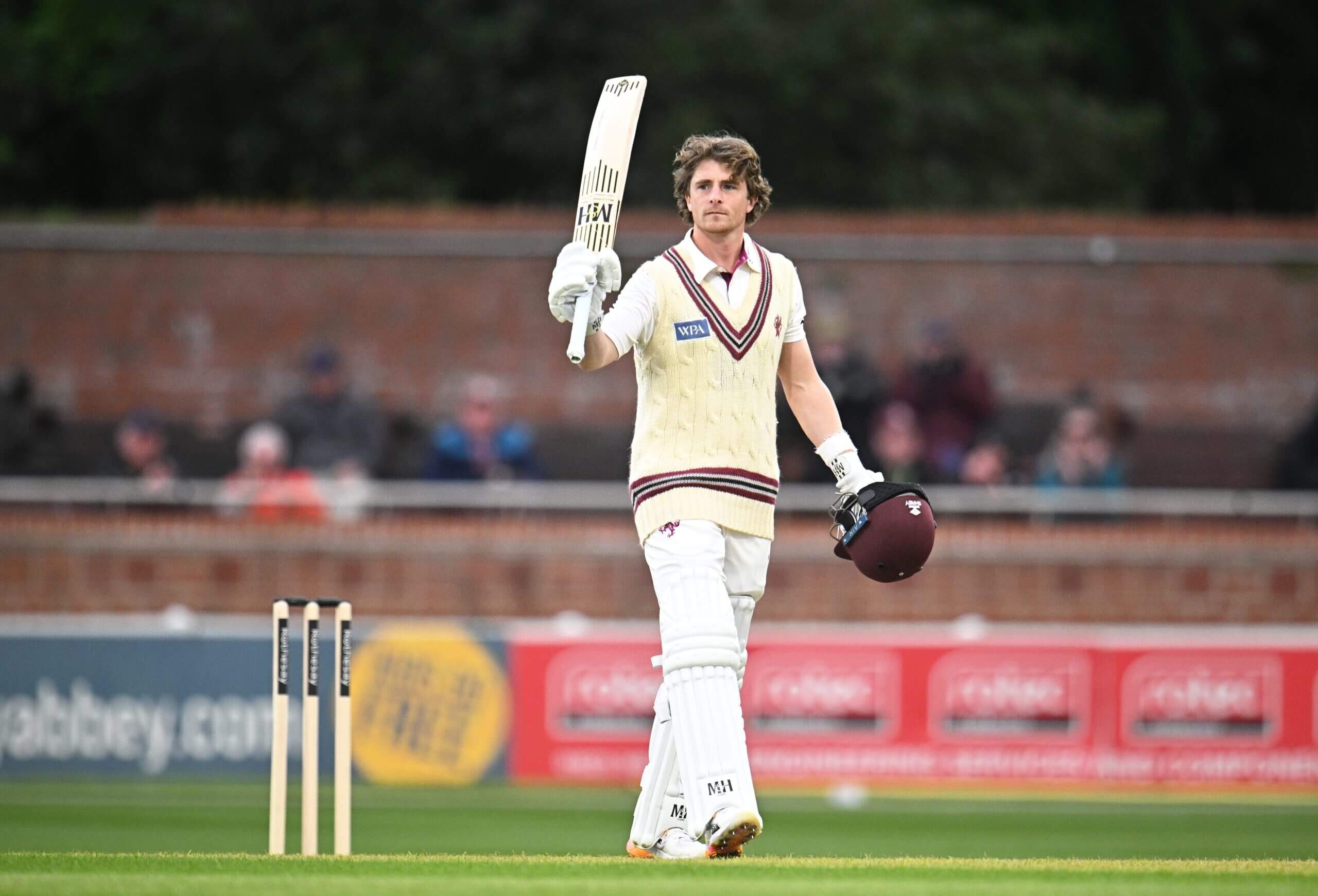 Young school cricketer in whites at a cricket ground